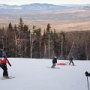 Ski patrol practicing towing skiier in the sled.