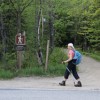 Gillian unintentionally posed as the hiker symbol on the sign.